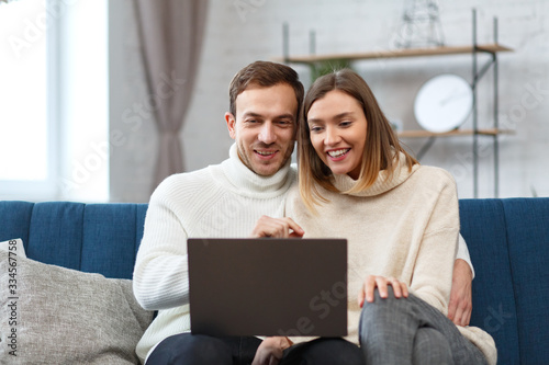 Stay home. Portrait of smiling family using laptop for a online meeting, video call, video conference with parents, children, relatives. Self-isolation. Spending time at home in quarantine period.