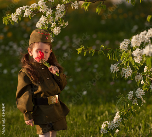 Young beautiful girl in uniform on May 9 Victory Day