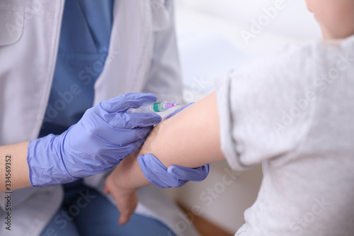 Little girl receiving chickenpox vaccination in clinic, closeup. Varicella virus prevention