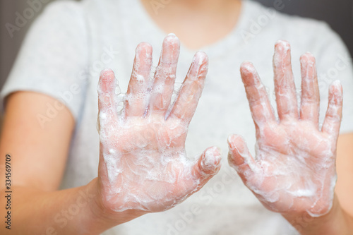 Front view on teenagers hands with soap foam, personal hygiene concept