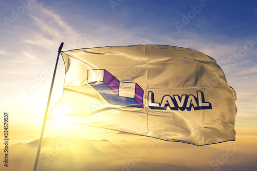 Laval of Quebec of Canada flag waving on the top sunrise mist fog photo