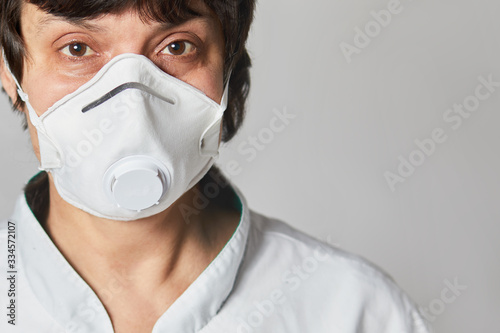 Close up portrait of a Doctor wearing a respirator N95 mask to protect from airborne respiratory diseases such as the flu, coronavirus, ebola, TB.