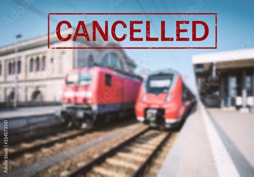 Trains cancelled due to pandemic of coronavirus. Passenger railway travel and transportation cancellation due to epidemic of Covid-19. Background with railway station, high speed train and text