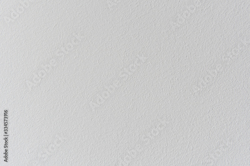 Textured concrete wall of the house. Decorative plaster. Abstract white background