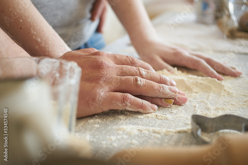 women s and men s hands mix wheat flour. baker s hand closeup.couple together Cooking pizza  bread