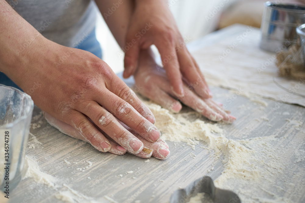 women's and men's hands mix wheat flour. baker's hand closeup.couple together Cooking pizza, bread