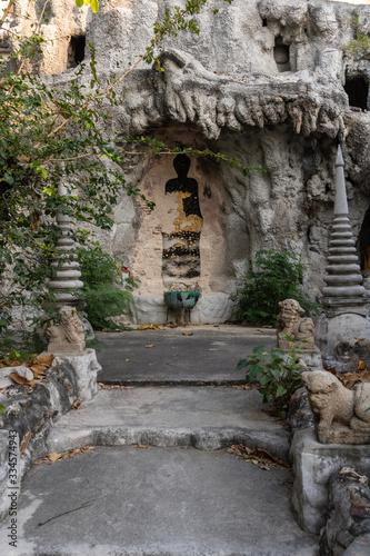 Buddha picture on the wall of man-made cave, vertical shot