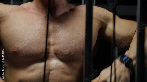  Bodybuilder shakes muscles in the gym. 