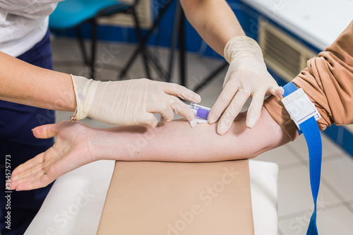 Covid-19, pandemic and viruses concept - Close-up of doctor takes blood on the analysis. © satura_