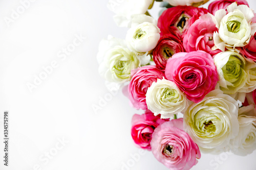 Macro shot of beautiful bouquet of pink & white ranunculus flowers with visible petal texture . Close up composition with bright patterns of flower buds with a lot of copy space for text. Top view. © Evrymmnt