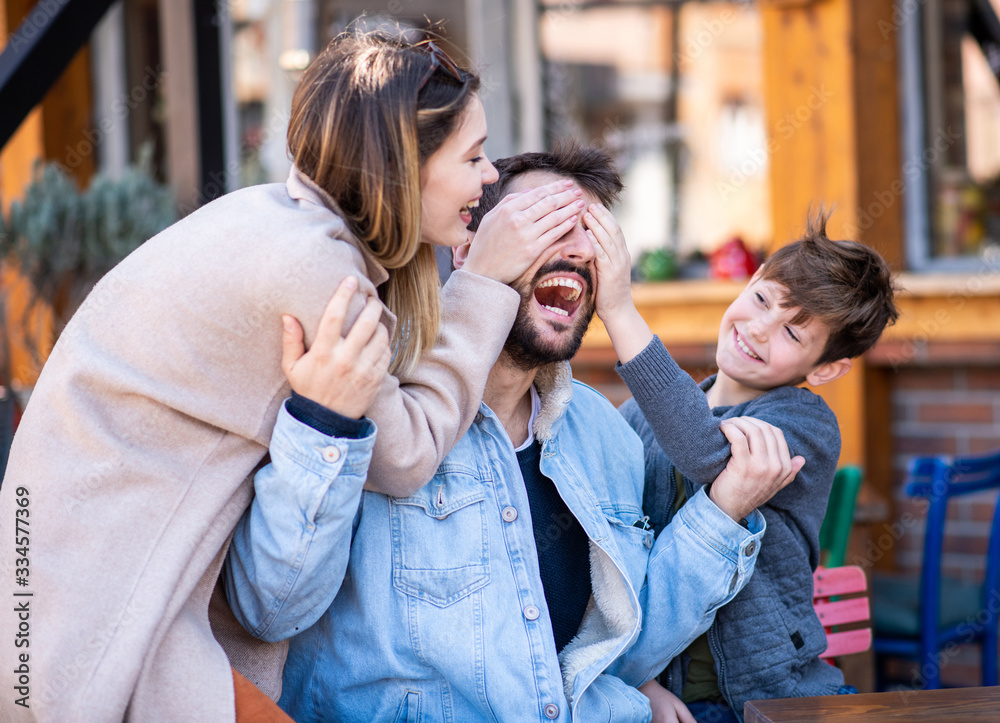 A family outside, laughing and spending their time together. A family outside, laughing and spending their time together.