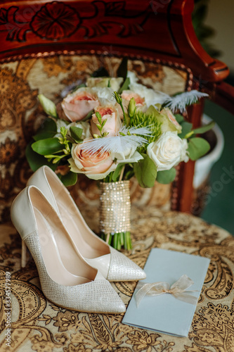  invitation card lies on a bouquet of cream roses