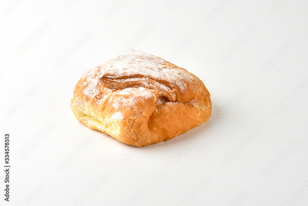 Bun dusted with icing sugar on a white background