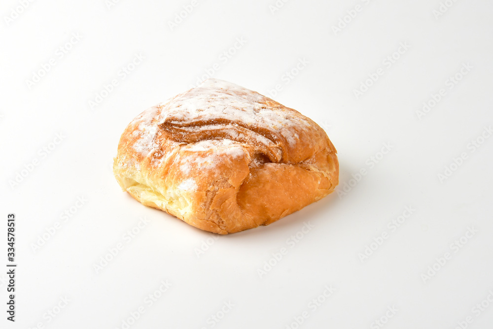 Bun dusted with icing sugar on a white background Bun dusted with icing sugar on a white background