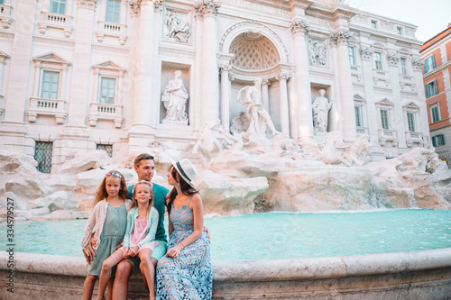 Happy young parents and little kids smiling traveling together on european travel vacation holiday in Europe