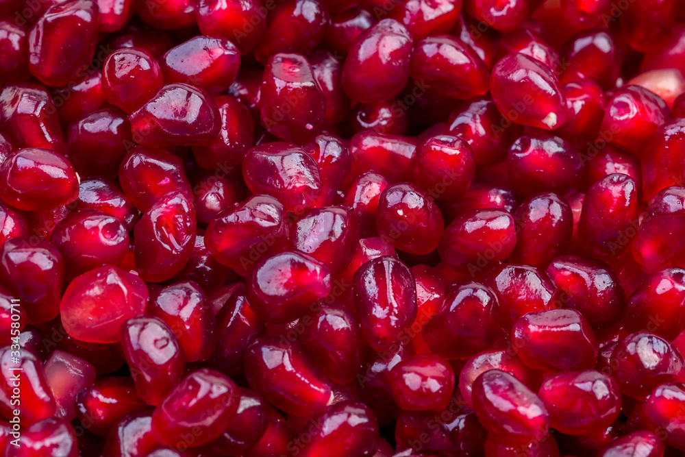 Texture of red ripe pomegranate seeds closeup