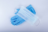 close up set of doctor gloves and medical mask on white background