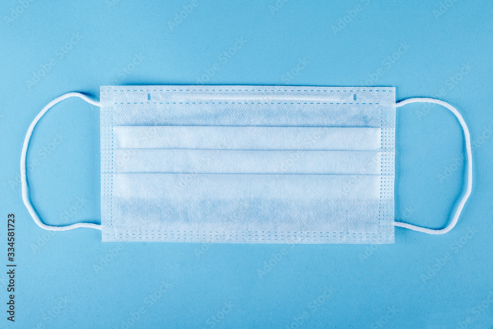 close-up of a medical mask on a blue background. protection from coronavirus