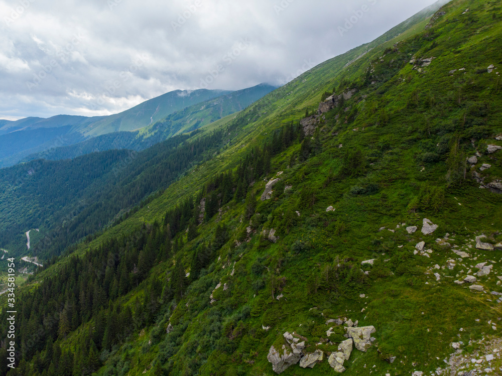 Obraz premium Romania. Fagaras mountain range. Mountain highway Transfagarash. One of the most beautiful roads in the world. Popular tourist route. Drone. Aerial view