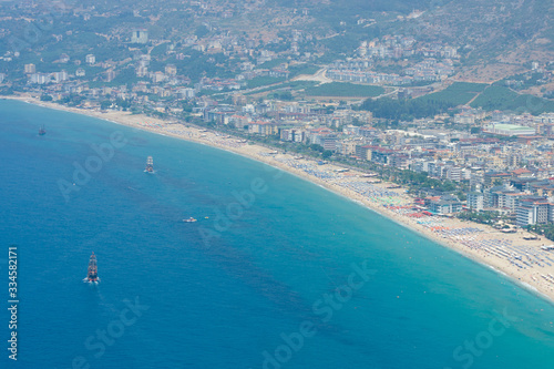 Alanya. Turkey. The city beach in Alanya. The coastline is receding into the distance. The view from the bird s eye view. Alanya - a popular holiday destination for European tourists.
