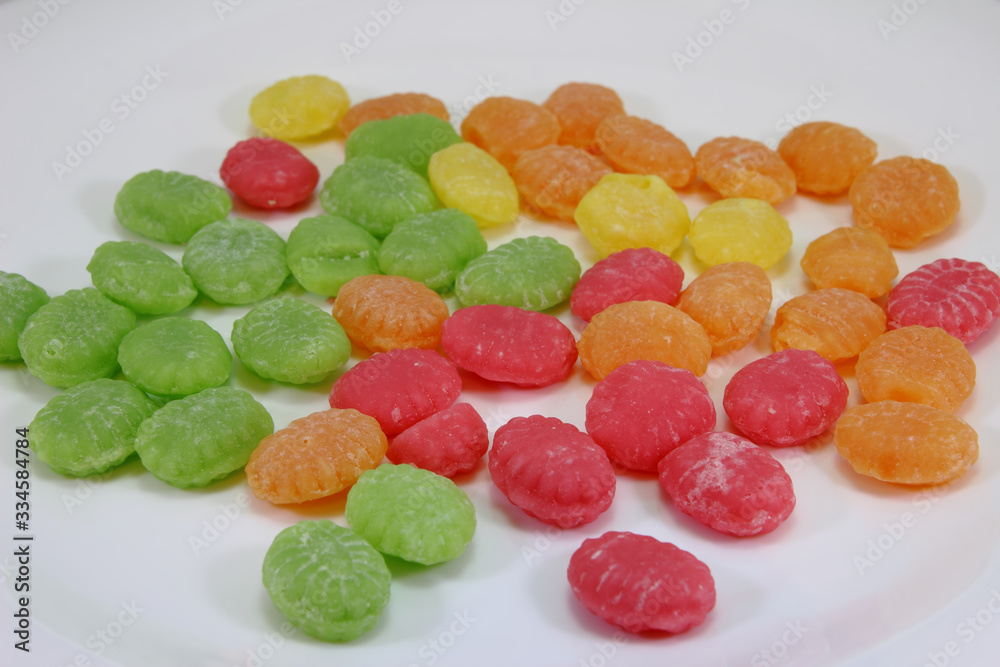 candies in different colors on a white background candies in different colors on a white background
