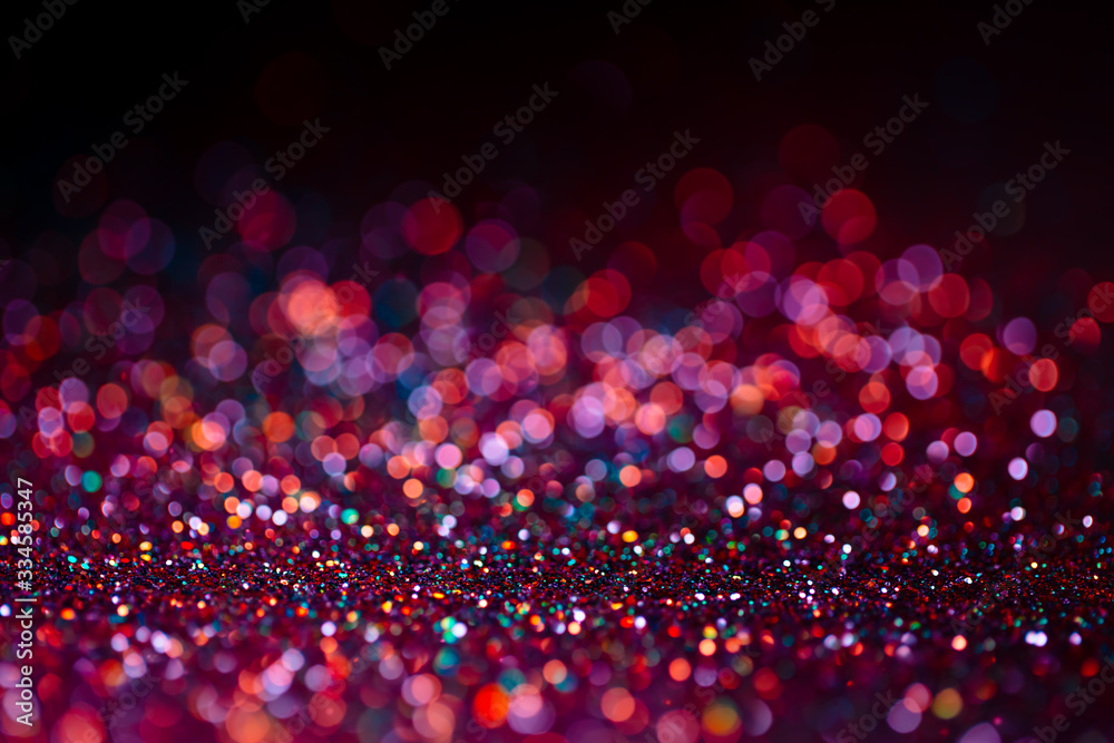 Decoration bokeh glitters background, abstract shiny backdrop with circles,modern design overlay with sparkling glimmers. Black, pink and orange backdrop glittering sparks with glow effect