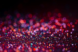 Decoration bokeh glitters background, abstract shiny backdrop with circles,modern design overlay with sparkling glimmers. Black, pink and orange backdrop glittering sparks with glow effect