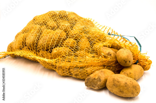 Ripe potatoes in burlap sack isolated