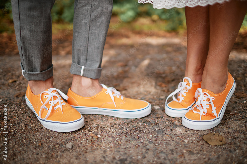 man and woman in yellow sneakers