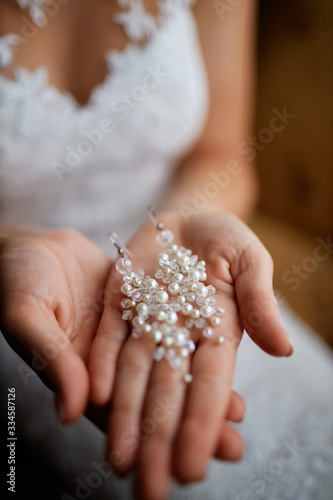 woman holds earrings in her hand