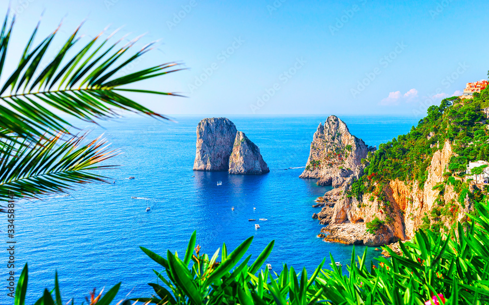 Ships at Faraglioni cliffs and Tyrrhenian Sea of Capri Island reflex