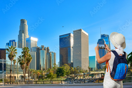 Tourist woman or girl taking photo in Los Angeles Downtown, California