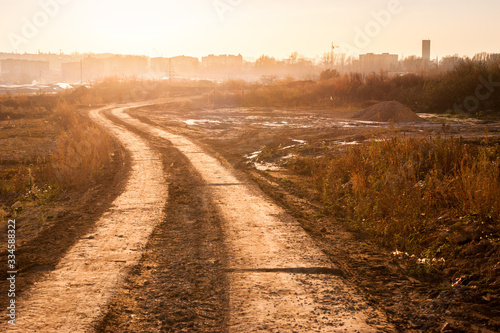 Landscape of a dirt road near a city