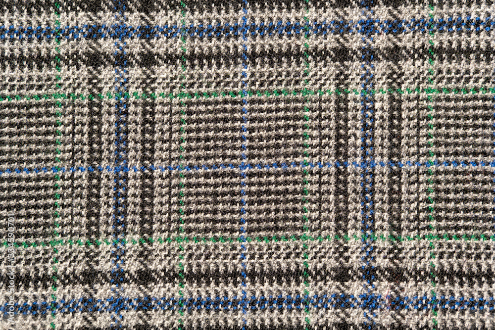 Plaid wool fabric background. Amazing texture of warm textile for winter coats.