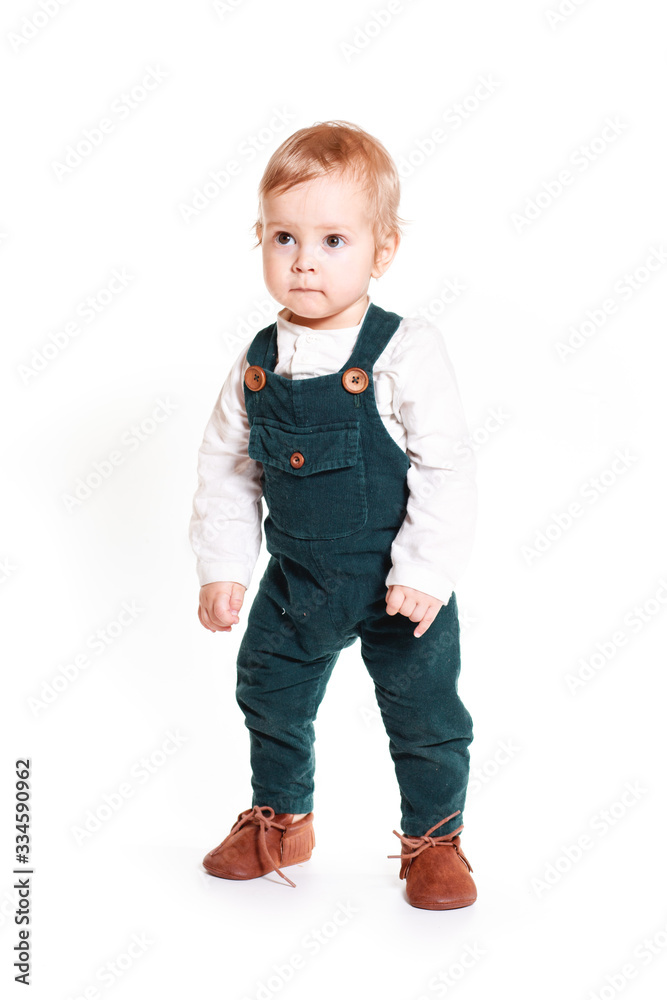 A one-year-old boy in a green jumpsuit A one-year-old boy in a green jumpsuit
