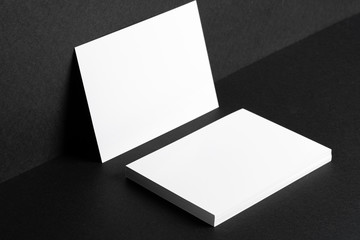White businesscards on black background close up, copy space