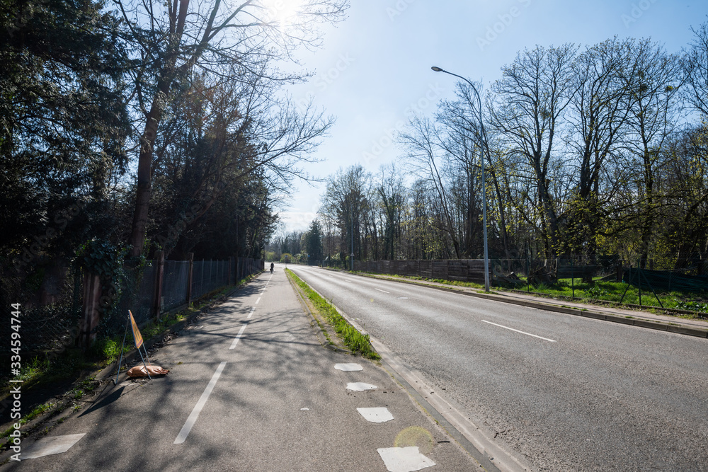 Silhouete of lonely cyclist on empty street in France due to coronavirus outbreak