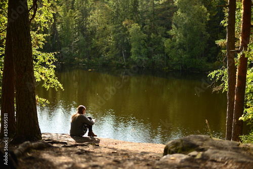 Fototapeta Naklejka Na Ścianę i Meble -  woman resting in a lake at a forests