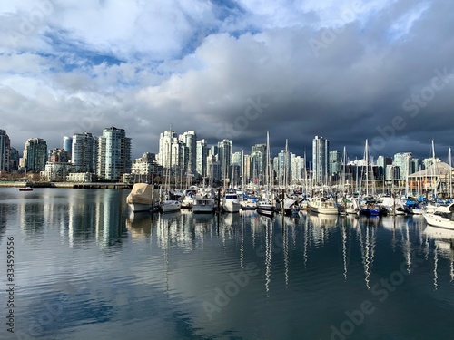 Vacouver skyline and marina boats with reflections in water in spring of global pandemic COVID-19. Vancouver  British Columbia  Canada. 