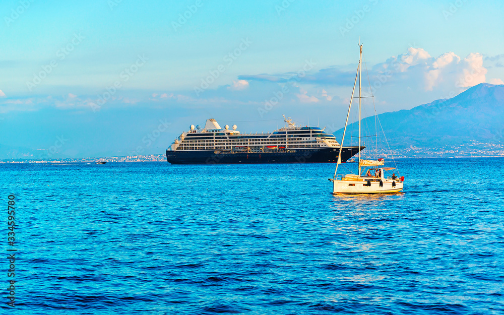 Obraz premium Cruise ship and boat at Marina Grande port in Sorrento reflex