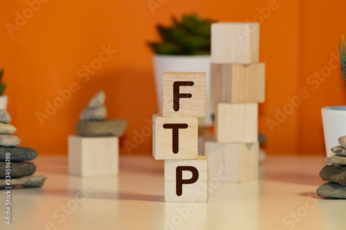 The Word FTP Formed By Wooden Blocks On A White Table photo