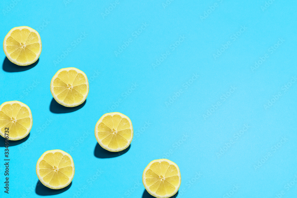 Minimal flat lay food texture. Summer abstract trendy fresh concept. Lemon pattern on bright light blue background, copy space. Minimal flat lay food texture. Summer abstract trendy fresh concept. Lemon pattern on bright light blue background, copy space.