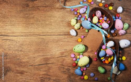 Colorful Easter candies on a rustic wood background
