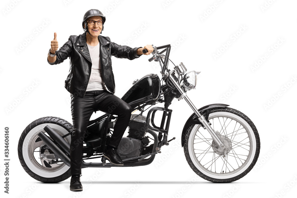 Cool senior biker sitting on a chopper motorbike and showing thumbs up Cool senior biker sitting on a chopper motorbike and showing thumbs up