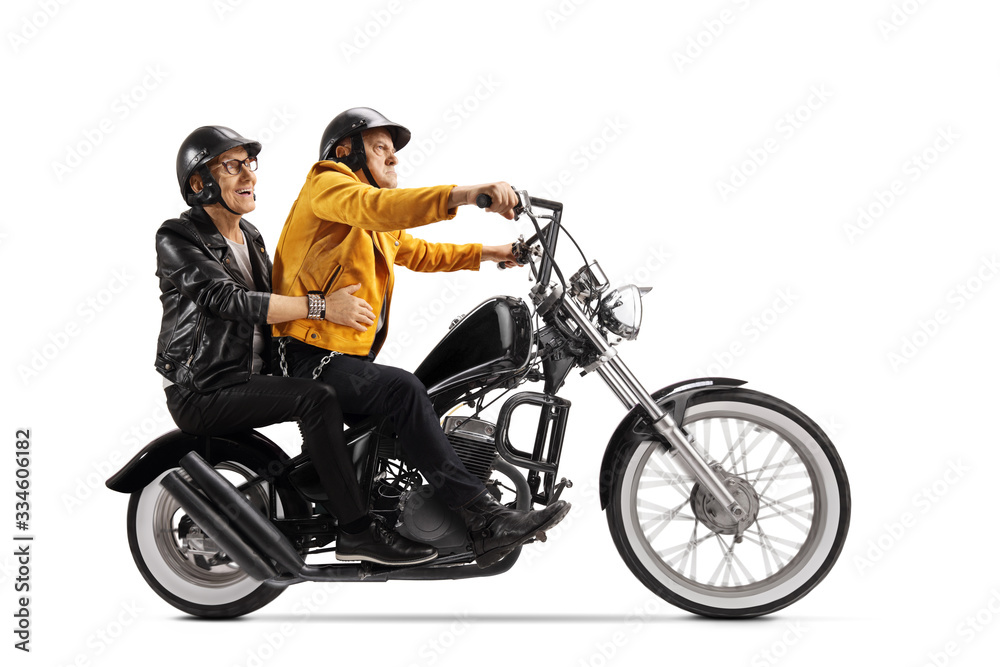 Two senior men riding on a chopper motorbike