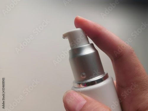 close up of hand holding spray bottle