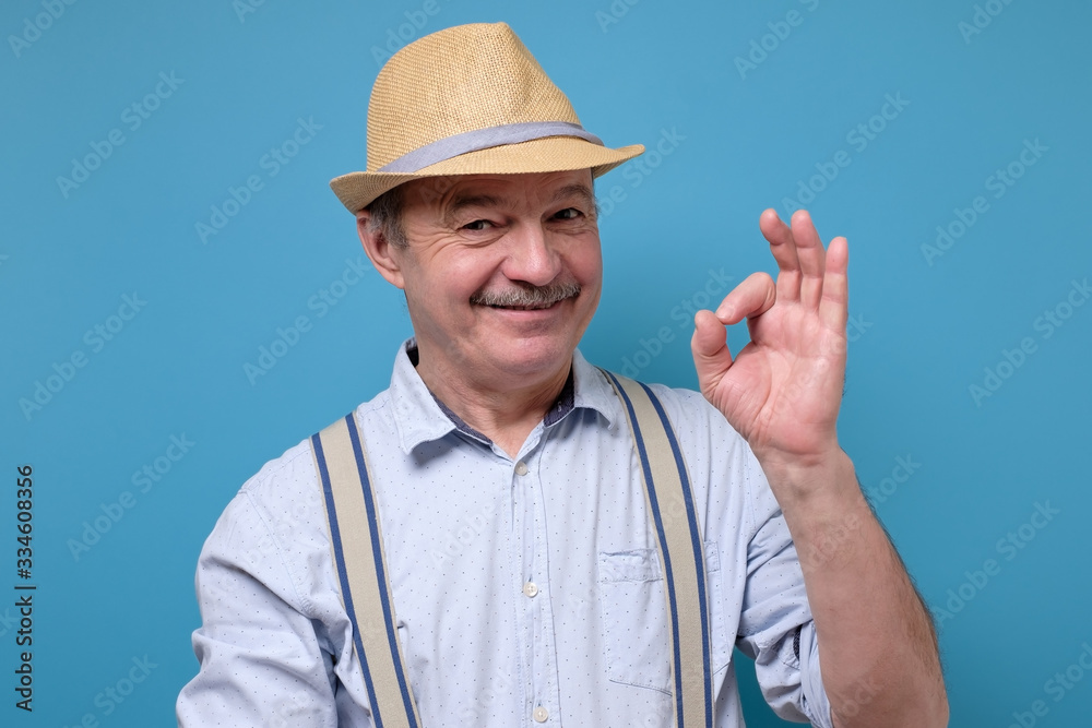 Senior spanish man showing OK sign approving choice. Senior spanish man showing OK sign approving choice.