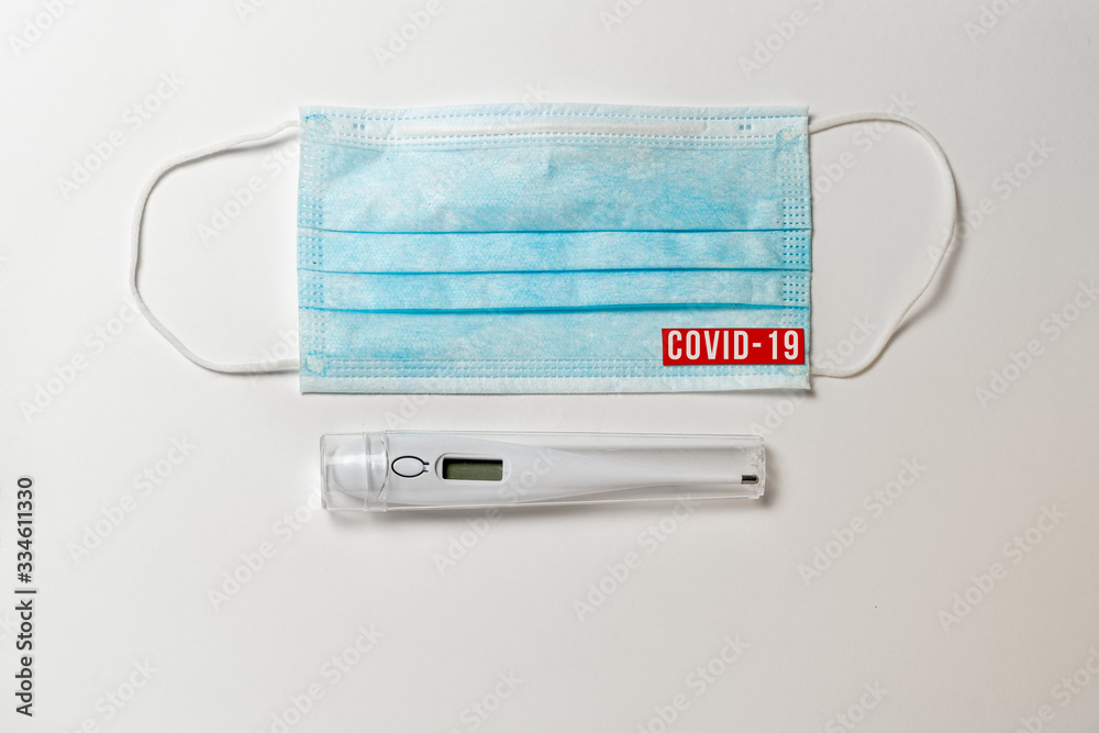 quarantine. Surgical mask and digital thermometer with text quarantine. Surgical mask and digital thermometer with text
