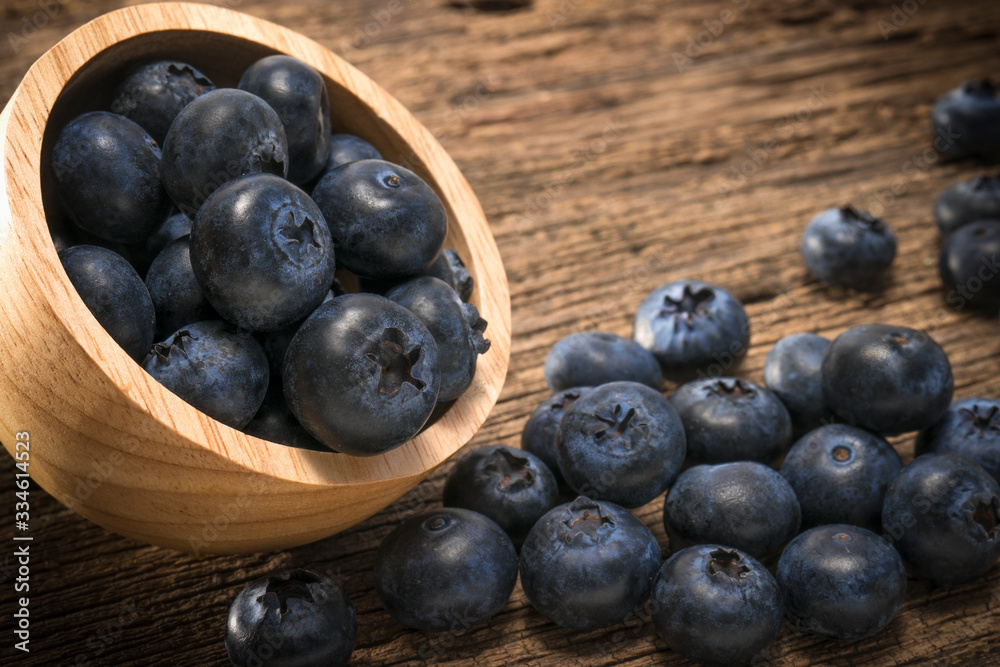Blueberries in bowl on on the wooden table, Fresh raw berries on wood background. Blueberries in bowl on on the wooden table, Fresh raw berries on wood background.