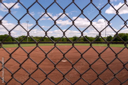 Baseball field through grid of chain link fence